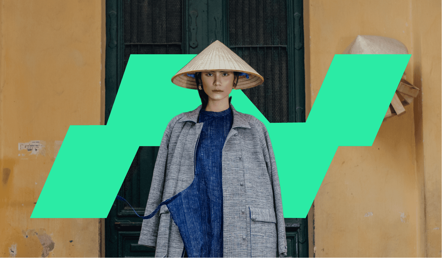 This is an image of a fashion model looking at the camera in the streets of Hanoi