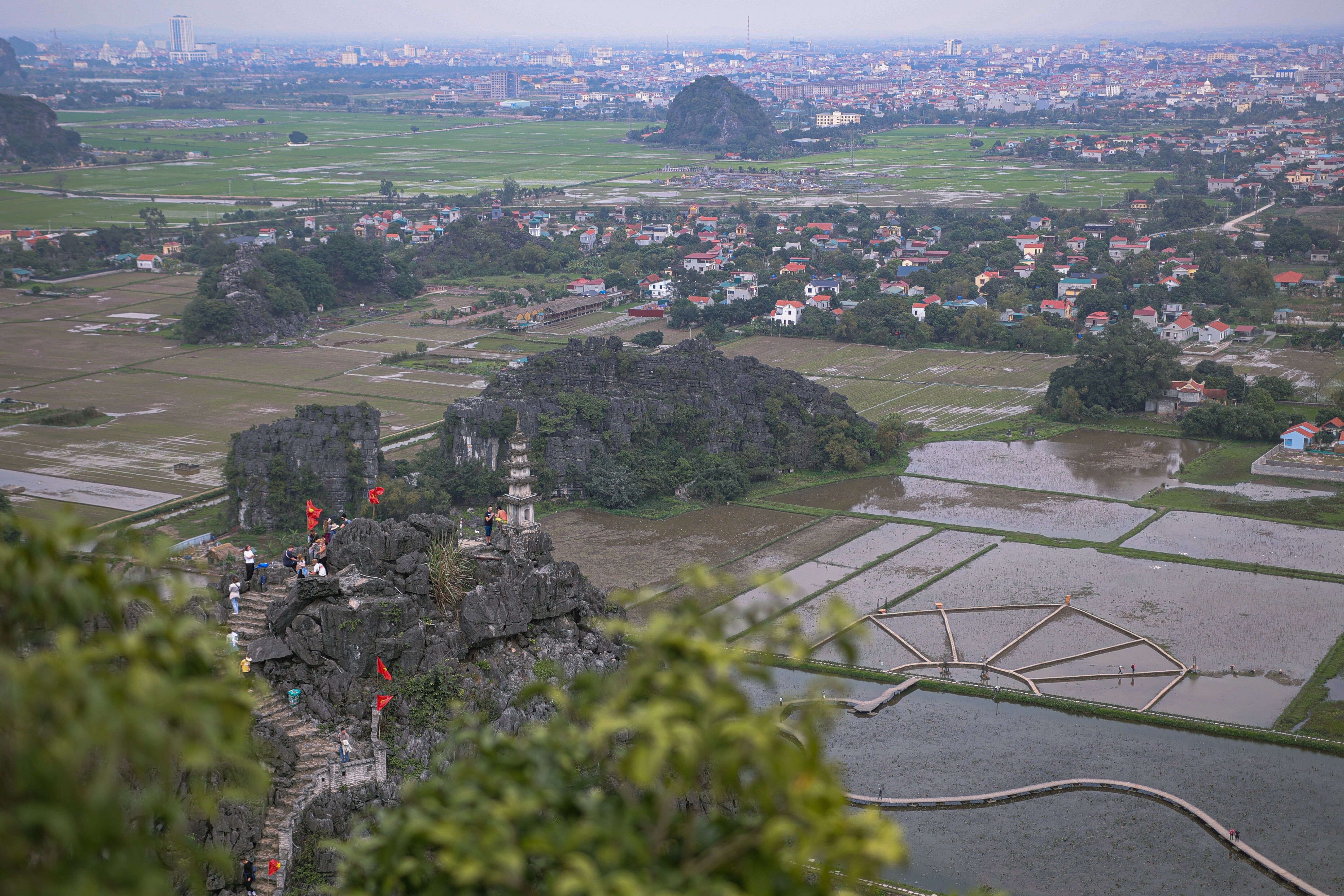 This is an image of Ninh Binh from afar, featuring the Hang Mua peak, agriculture and villages