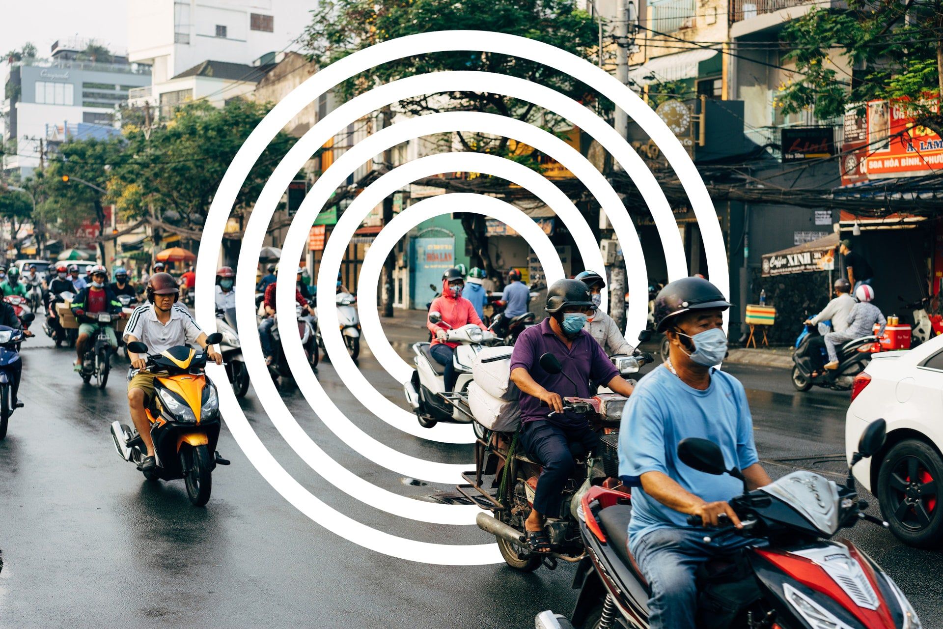 This is an image of people on motorbikes in Vietnam with a circular graphical element zooming in on one driver